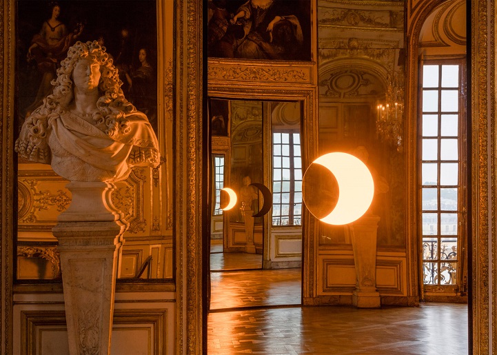 Glowing crescent-shaped light reflected in an ornate room